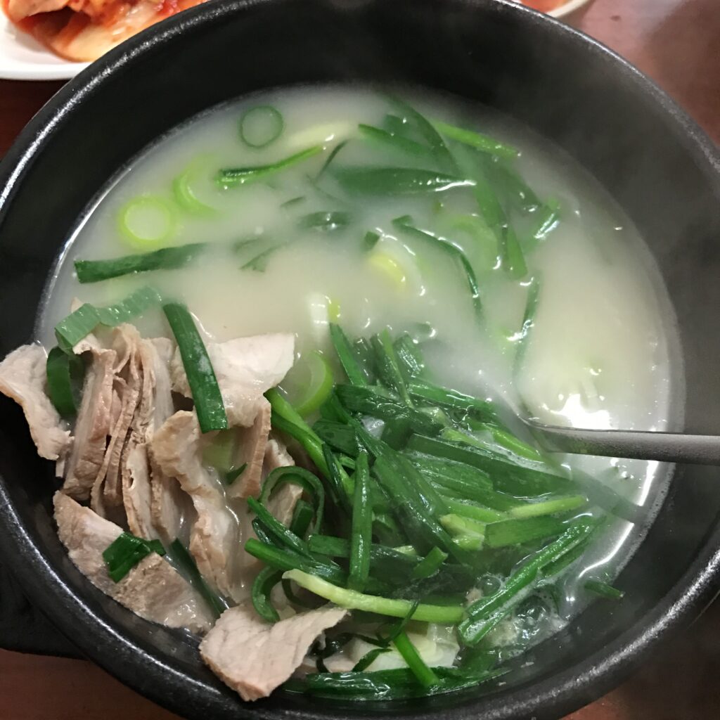 Dwaeji-gukbap, Busan's signature pork-and-rice soup, served with rice and condiments. (Wikimedia Commons)