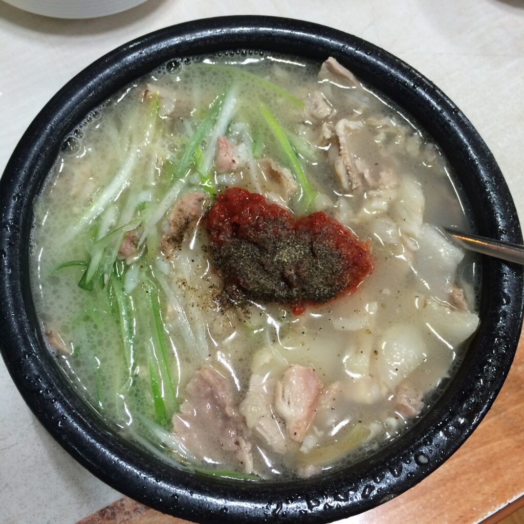 Adding dadaegi, the chili-garlic paste, to the soup. (Wikimedia Commons)