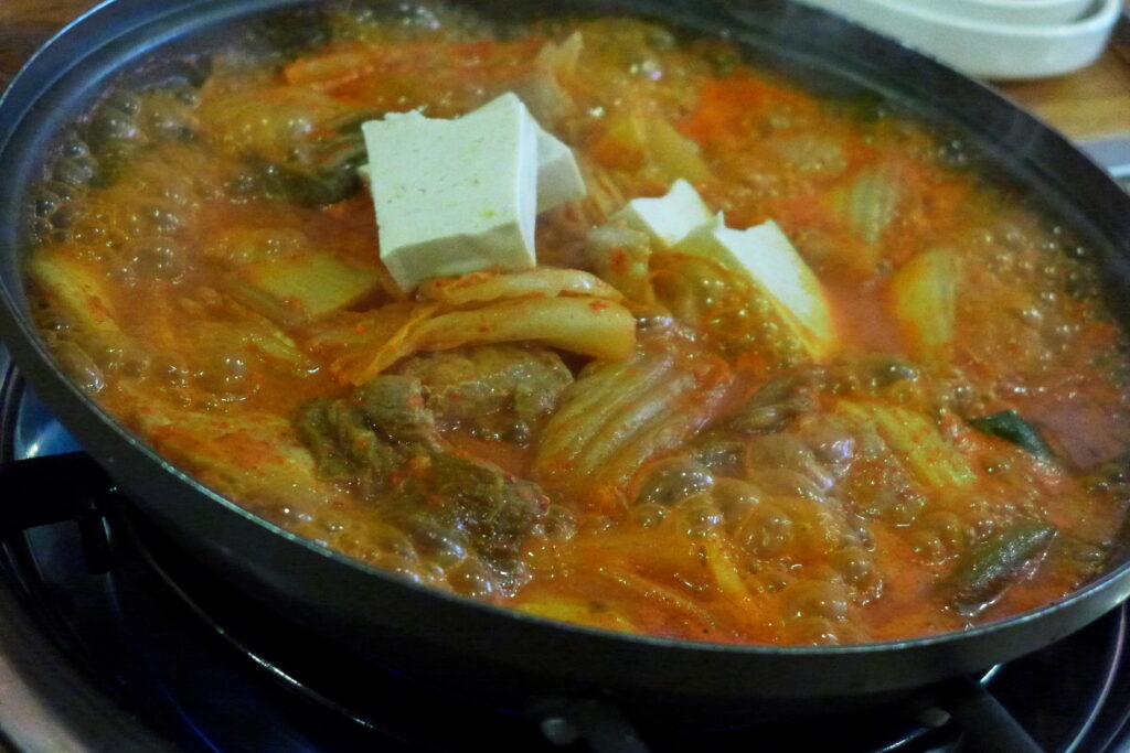 Kimchi-jjigae, rich and red from well-fermented kimchi. (Wikimedia Commons)