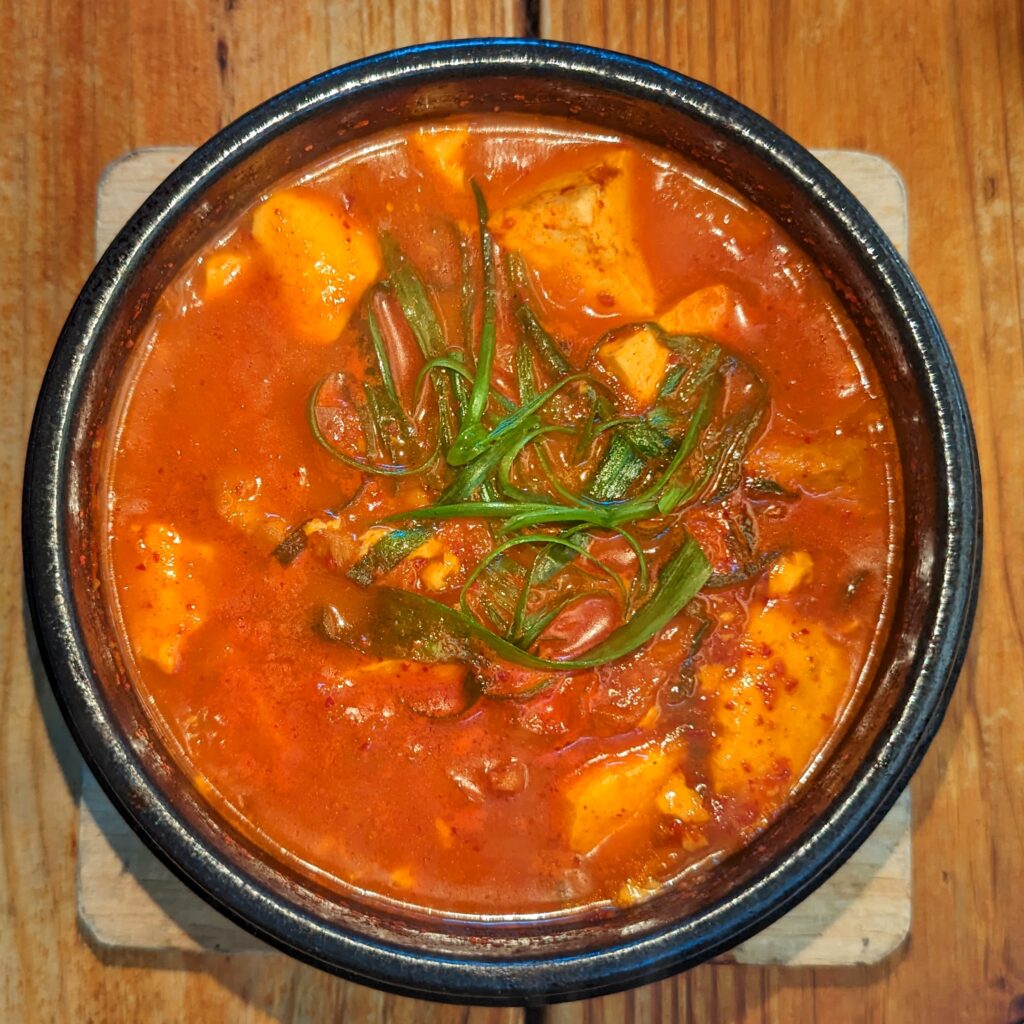A bubbling pot of kimchi-jjigae - the more sour the kimchi, the better. (Wikimedia Commons)