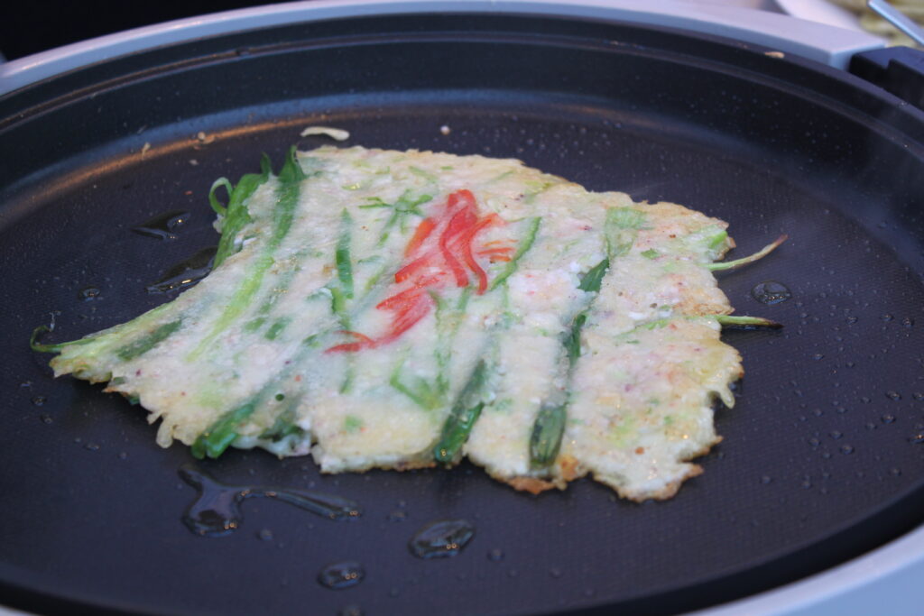 Pajeon frying in the pan until crisp. (Wikimedia Commons)