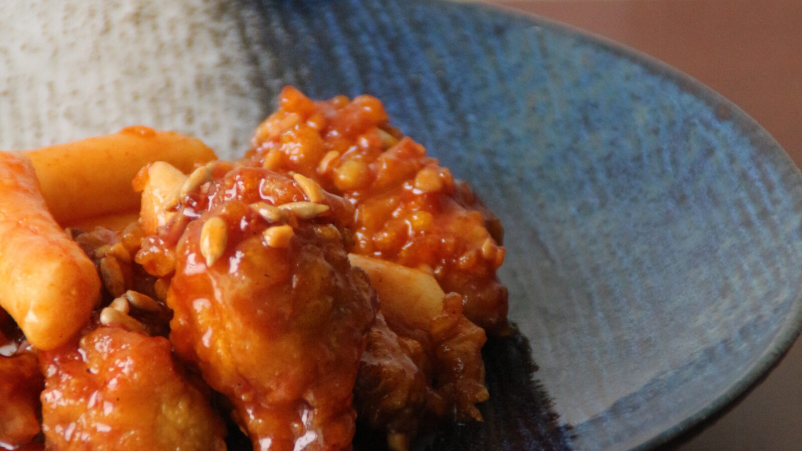 Dakgangjeong, Korean sweet and crispy double-fried chicken, served on a plate.