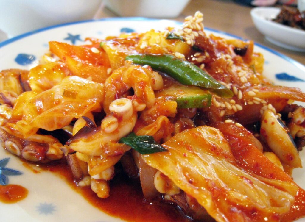 낙지 (nakji) — Nakji-bokkeum, spicy stir-fried octopus (signature octopus dish) — a representative photo of the dish, not necessarily from the restaurants above. Photo: Beng Han Ho (via Flickr), CC BY-SA 2.0, via Wikimedia Commons