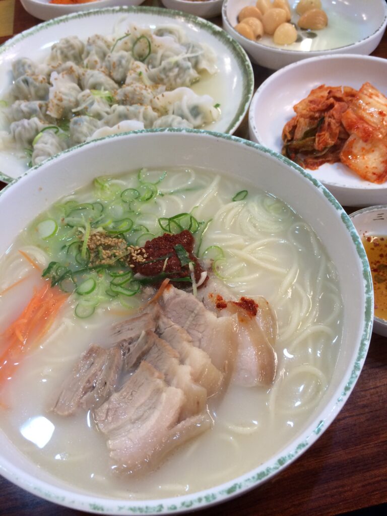 고기국수 (Gogi-guksu, Jeju pork-noodle soup) — a representative photo of the dish, not necessarily from the restaurants above. Photo: Photo by Narnars0, via Wikimedia Commons, licensed CC BY-SA 3.0