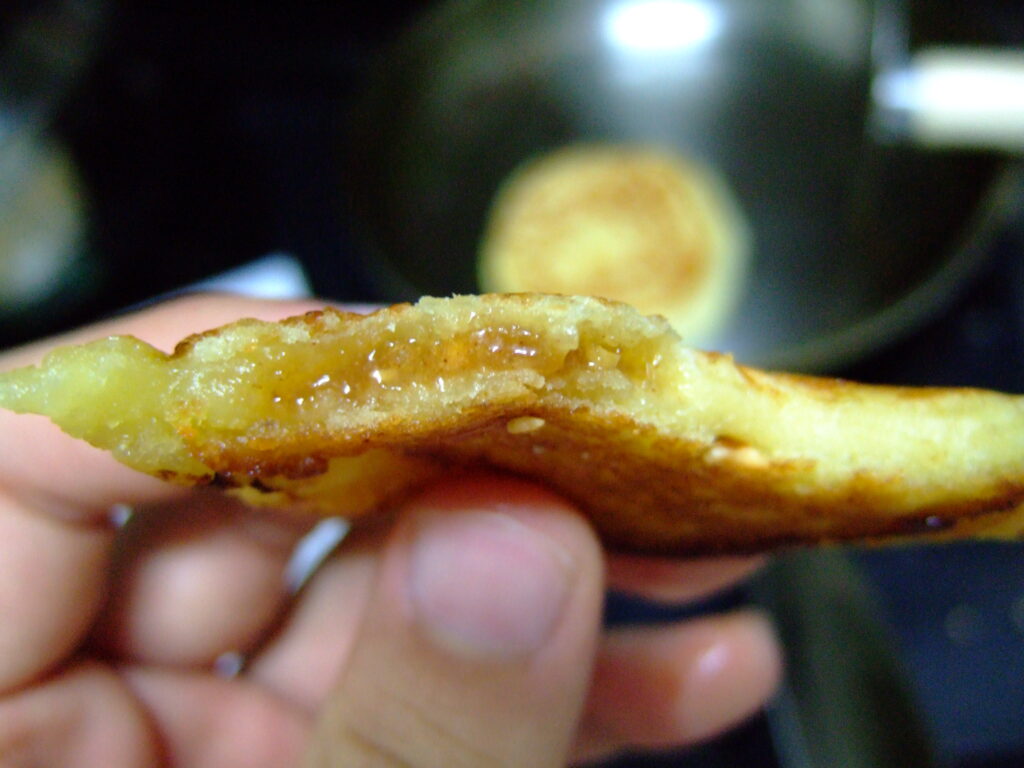 Torn open to show the molten brown-sugar and cinnamon filling. Photo: keizie / CC BY 2.0, via Wikimedia Commons
