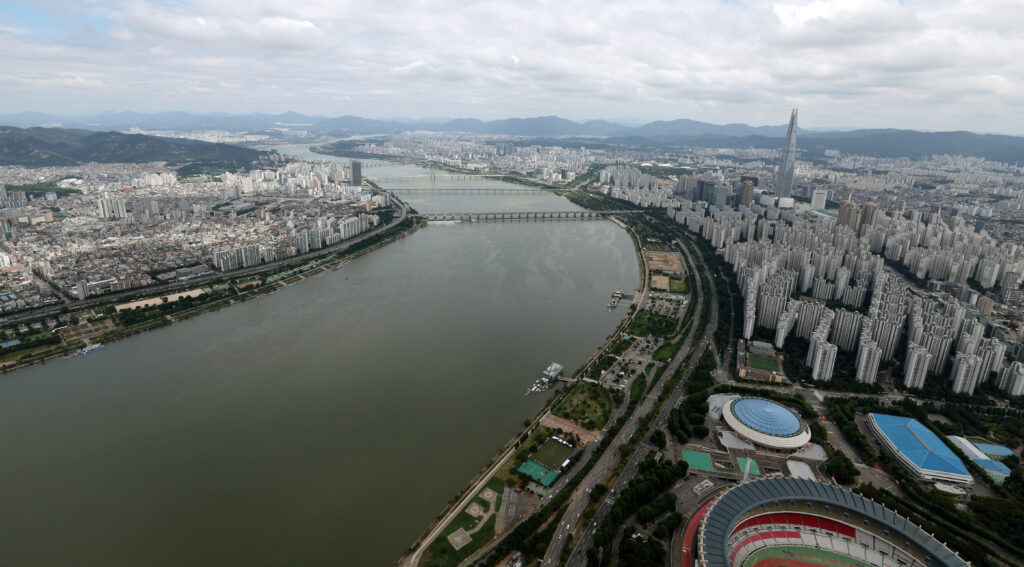 Aerial view of Seoul including the Jamsil area and Seoul Olympic Stadium (lower right), part of the Seoul Sports Complex where much of Netflix's "Parasyte: The Grey" was filmed. (Photo: Jeon Han / Korean Culture and Information Service, CC BY-SA 2.0 via Wikimedia Commons)