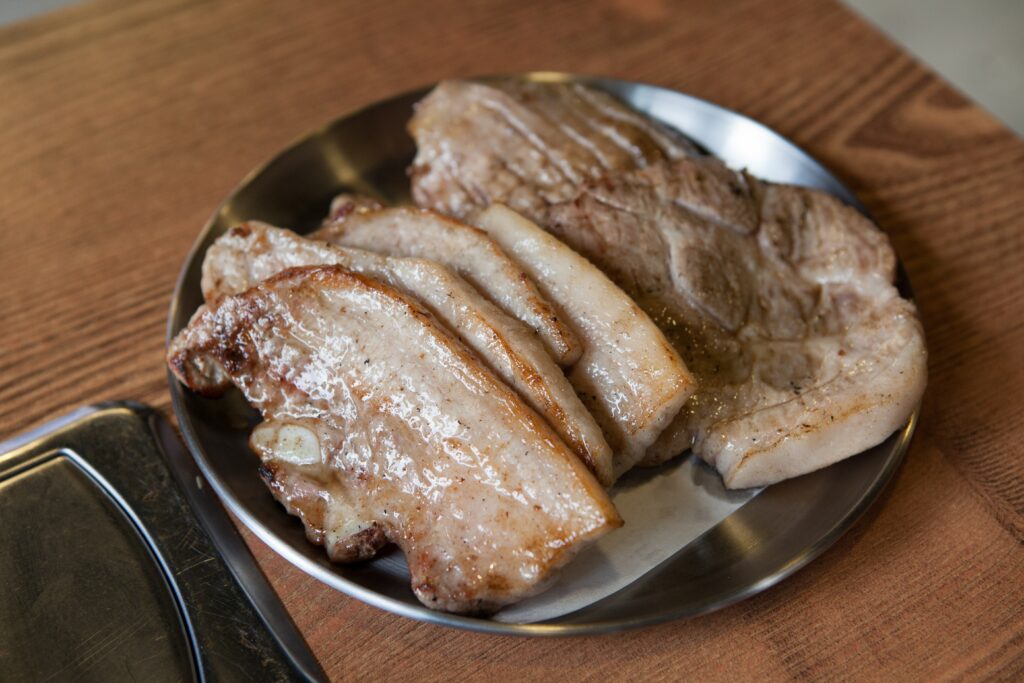 Samgyeopsal-gui: strips of pork belly grilling on a tabletop grill, the classic Korean BBQ scene. (Photo: jinsoo jang via Pixabay, CC0 / public domain)
