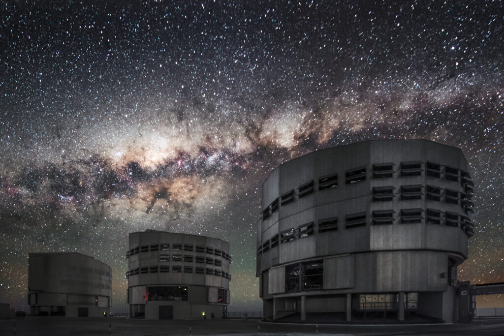 The Milky Way arching over ESO's Very Large Telescope at Paranal Observatory — an illustrative outer-space night-sky image evoking the cosmic isolation of 'The Silent Sea' (not an actual filming location). (Photo: ESO/A. Ghizzi Panizza, CC BY 4.0 via Wikimedia Commons)