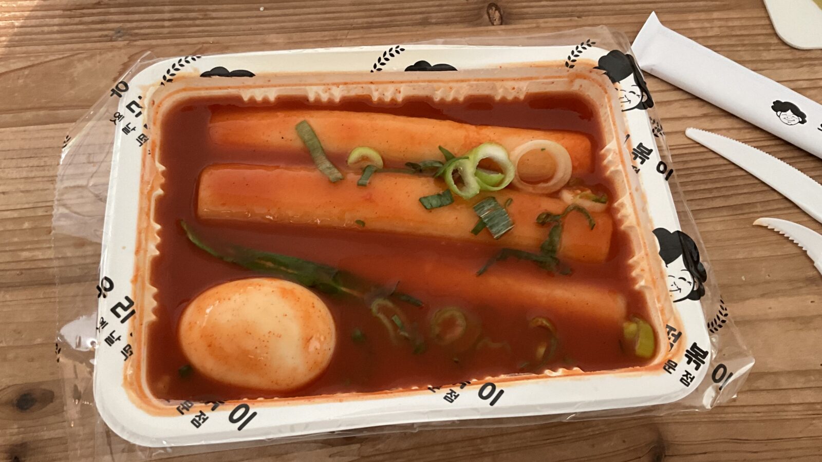 떡볶이 (tteokbokki) made with 가래떡 cylindrical rice cakes in a glossy, spicy red 고추장 sauce.
