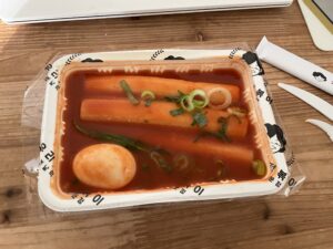 떡볶이 (tteokbokki) made with 가래떡 cylindrical rice cakes in a glossy, spicy red 고추장 sauce.
